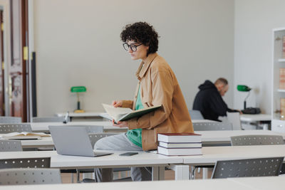 Side view of businesswoman working at office