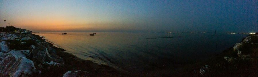 Scenic view of sea against clear sky at sunset