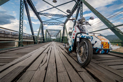 Motor scooter on footbridge