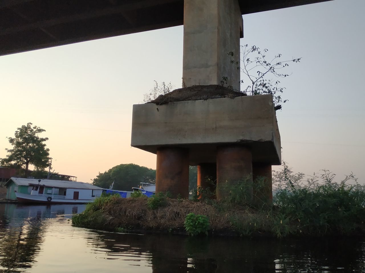 VIEW OF BRIDGE OVER LAKE AGAINST BUILDINGS