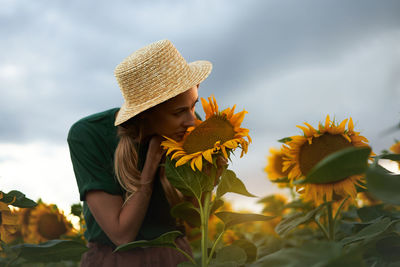 Low angle view of person wearing hat against plants