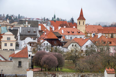 Houses and buildings in town against sky