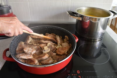 Midsection of person preparing food in kitchen