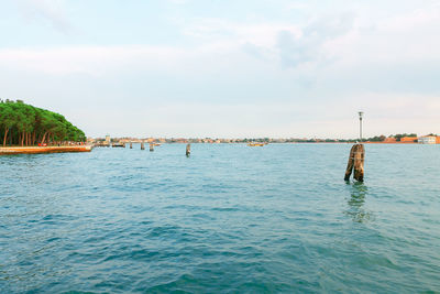 Venice water canal with old wooden berth . water surface of lagoon in venezia