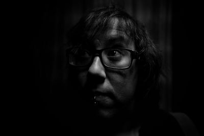 Close-up of woman wearing eyeglasses looking away