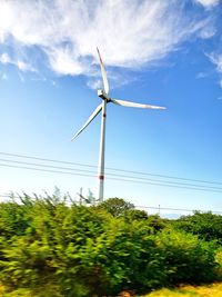 Low angle view of wind turbine against sky