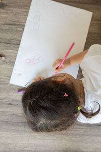 High angle view of child on table