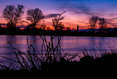 Scenic view of lake against sky during sunset