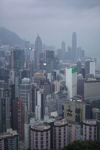 Aerial view of buildings in city against sky