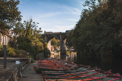 Arch bridge over river against sky