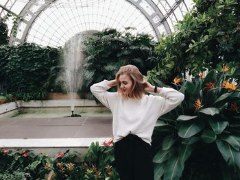 Woman wearing hat against plants