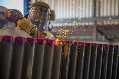 Worker welding metal at workshop