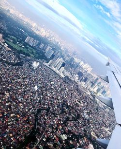 Aerial view of city and buildings against sky