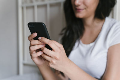 Midsection of woman using mobile phone