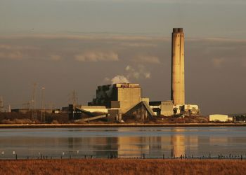 Factory against sky in city