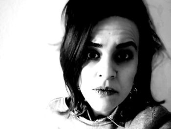 Close-up portrait of beautiful young woman over white background