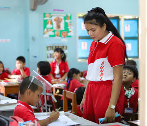 Teacher and students are studying in school in thailand.