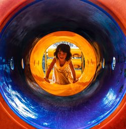 Portrait of boy playing in tunnel
