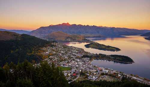Aerial view of queenstown by lake during sunset