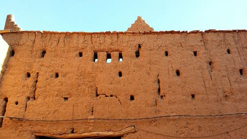 Low angle view of old building against clear sky