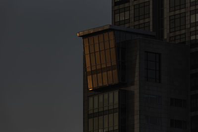 Low angle view of modern building against sky at night