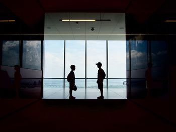 Silhouette people standing at airport