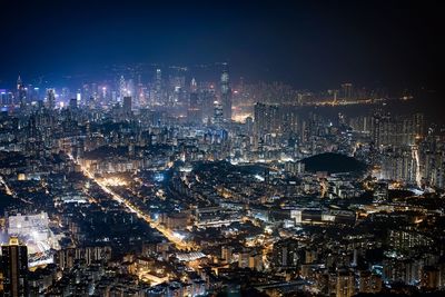 Illuminated cityscape against sky at night