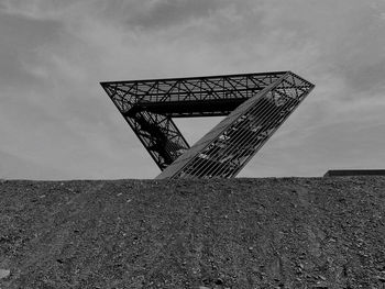 Low angle view of metallic structure against sky