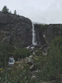 Close-up of water flowing in farm against sky