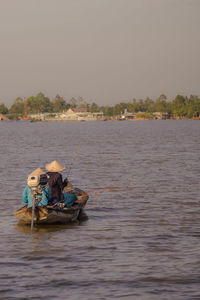 People kayaking in sea