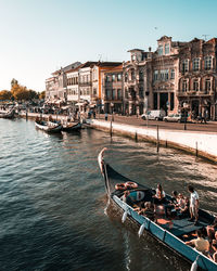 People in boat on canal against sky