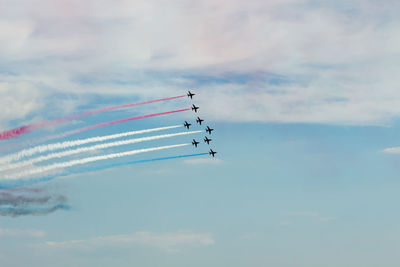 Low angle view of airshow against sky