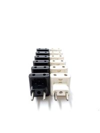 High angle view of three pin plugs on white background