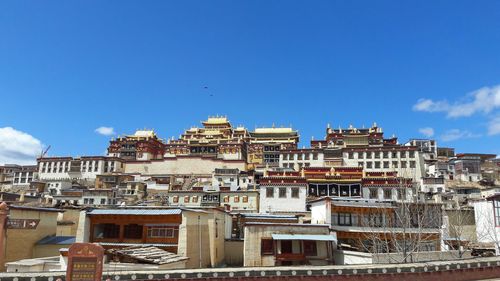 Low angle view of buildings against blue sky