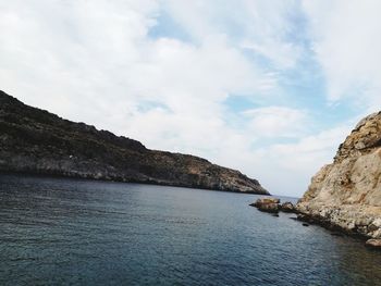 Scenic view of sea and mountains against sky