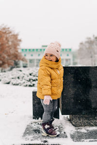 Full length of girl standing on snow