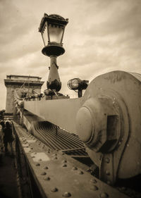 Low angle view of old machinery against sky