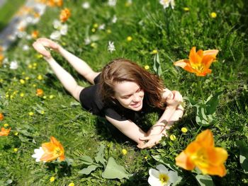 Young woman lying down on field
