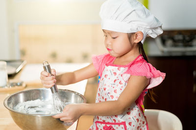 Girl holding ice cream at home