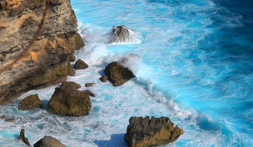 High angle view of rocks on sea