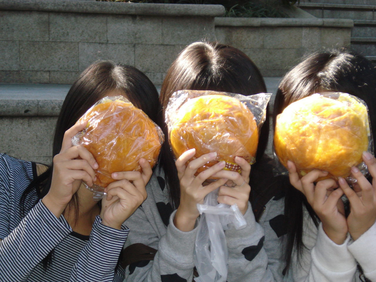 food, food and drink, holding, group of people, women, child, human hand, people, real people, togetherness, portrait, friendship, headshot, human body part, lifestyles, females, front view, adult, wellbeing, hairstyle, obscured face