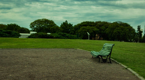 Chairs on landscape against sky