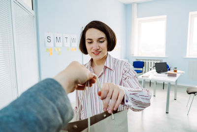 Meal delivery services, express office food lunch delivery. young smiling business woman working at