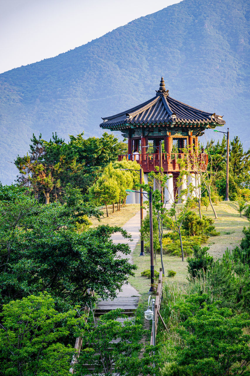 TEMPLE BY BUILDING AGAINST SKY