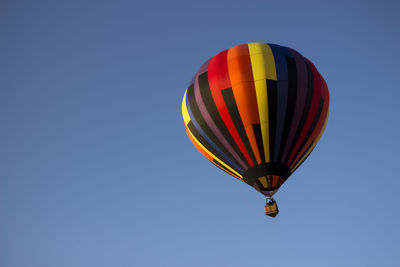 Low angle view of colorful hot air balloon against blue sky