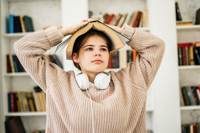 Portrait of young woman reading book