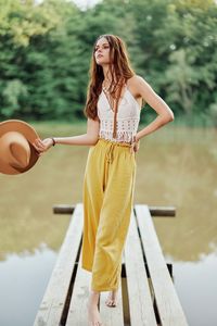 Portrait of young woman standing on boardwalk