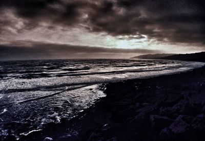 Scenic view of sea against cloudy sky