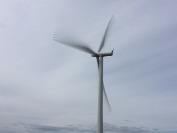 Low angle view of wind turbine against sky