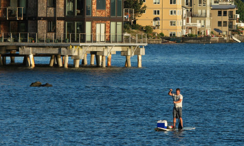 High angle view of man paddleboarding in sea